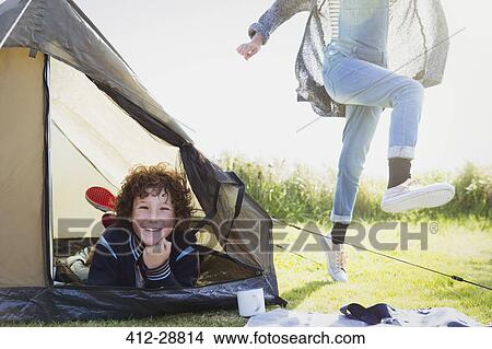 Picture - Portrait smiling boy inside tent. Fotosearch
