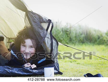 Portrait smiling boy inside tent View Large Photo Image Stock Photo - Portrait smiling boy inside tent. Fotosearch