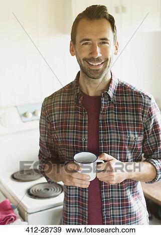 Portrait smiling brunette man drinking coffee in kitchen View Large Photo Image Stock Photo - Portrait smiling brunette man drinking coffee in kitchen. Fotosearch