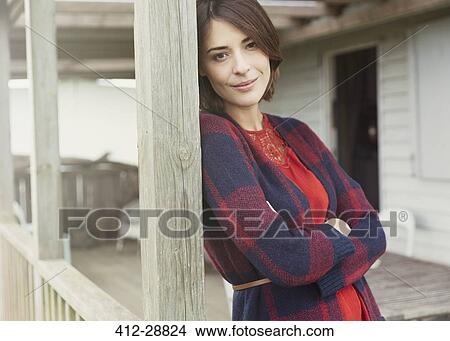 Portrait smiling brunette woman in sweater on porch View Large Photo Image Picture - Portrait smiling brunette woman in sweater on porch. Fotosearch