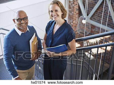 Portrait smiling businessman and businesswoman in stairway View Large Photo Image Picture - Portrait smiling businessman and businesswoman in stairway. Fotosearch