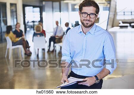 Portrait smiling businessman in office View Large Photo Image Stock Image - Portrait smiling businessman in office. Fotosearch