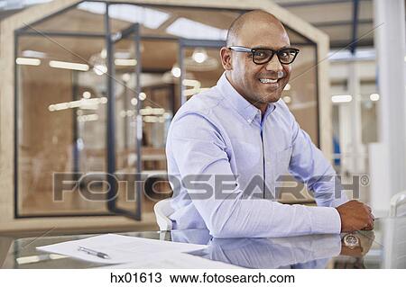 Portrait smiling businessman in office View Large Photo Image Stock Image - Portrait smiling businessman in office. Fotosearch