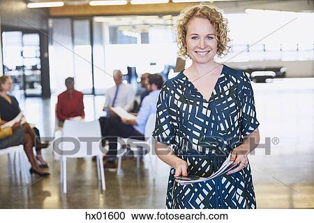 Stock Image - Portrait smiling businesswoman in office. Fotosearch