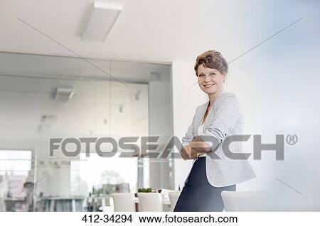 Portrait smiling businesswoman in conference room View Large Photo Image Picture - Portrait smiling businesswoman in conference room. Fotosearch