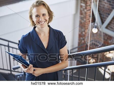 Portrait smiling businesswoman in stairway View Large Photo Image Stock Photo - Portrait smiling businesswoman in stairway. Fotosearch