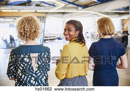 Portrait smiling businesswoman walking in office View Large Photo Image Stock Image - Portrait smiling businesswoman walking in office. Fotosearch