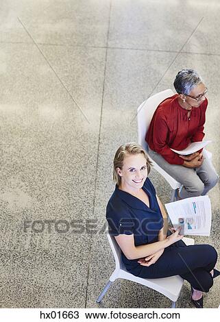 Portrait smiling businesswoman with paperwork in meeting View Large Photo Image Stock Image - Portrait smiling businesswoman with paperwork in meeting. Fotosearch