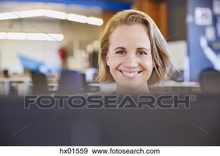 Portrait smiling businesswoman working at computer View Large Photo Image Stock Photo - Portrait smiling businesswoman working at computer. Fotosearch