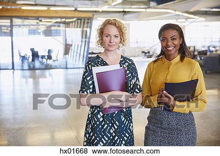 Stock Photo - Portrait smiling businesswomen in office. Fotosearch
