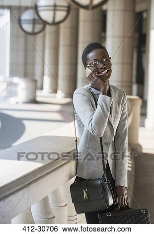 Portrait smiling corporate businesswoman talking on cell phone View Large Photo Image Stock Photograph - Portrait smiling corporate businesswoman talking on cell phone. Fotosearch