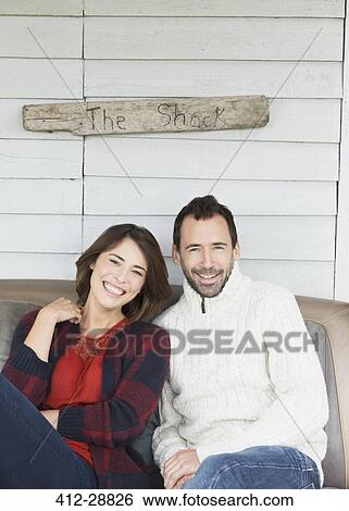 Portrait smiling couple on porch below “The Shack” sign View Large Photo Image Stock Photograph - Portrait smiling couple on porch below “The Shack” sign. Fotosearch