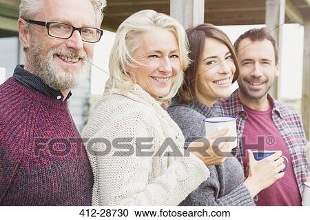 Stock Image - Portrait smiling couples drinking coffee outdoors. Fotosearch