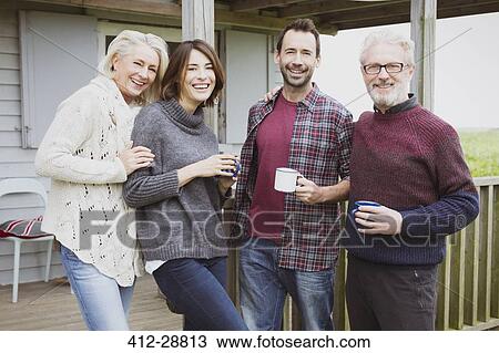 Portrait smiling couples drinking coffee on porch View Large Photo Image Stock Image - Portrait smiling couples drinking coffee on porch. Fotosearch
