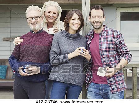 Stock Photograph - Portrait smiling couples drinking coffee outdoors. Fotosearch