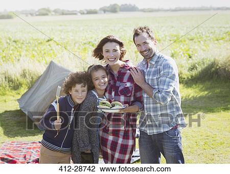 Portrait smiling family with barbecued hamburgers at sunny campsite View Large Photo Image Stock Image - Portrait smiling family with barbecued hamburgers at sunny campsite. Fotosearch