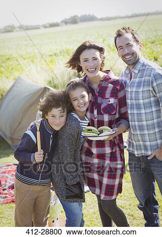 Portrait smiling family with barbecued hamburgers at sunny campsite View Large Photo Image Stock Image - Portrait smiling family with barbecued hamburgers at sunny campsite. Fotosearch