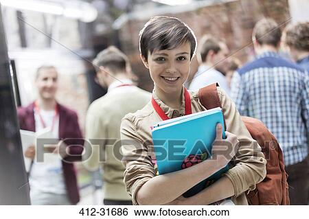 Portrait smiling female college student with backpack and laptop View Large Photo Image Stock Photograph - Portrait smiling female college student with backpack and laptop. Fotosearch