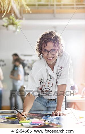 Portrait smiling female design professional editing proofs in office View Large Photo Image Stock Photography - Portrait smiling female design professional editing proofs in office. Fotosearch