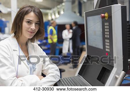 Portrait smiling female engineer at control panel in steel factory View Large Photo Image Stock Image - Portrait smiling female engineer at control panel in steel factory. Fotosearch