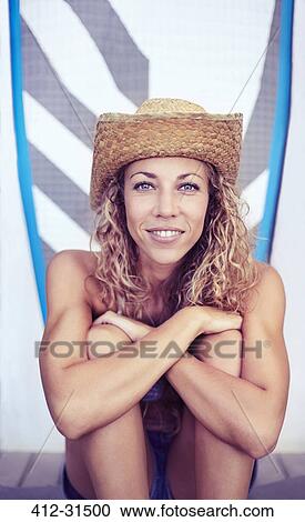 Portrait smiling female surfer in straw hat sitting in front of surfboard View Large Photo Image Stock Image - Portrait smiling female surfer in straw hat sitting in front of surfboard. Fotosearch
