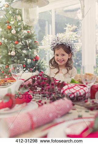 Stock Photo - Portrait smiling girl at Christmas table. Fotosearch