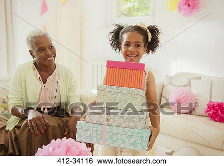 Portrait smiling girl carrying stack of birthday gifts View Large Photo Image Stock Photograph - Portrait smiling girl carrying stack of birthday gifts. Fotosearch