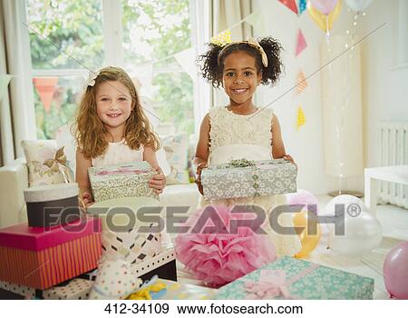 Portrait smiling girls holding birthday gifts View Large Photo Image Stock Photo - Portrait smiling girls holding birthday gifts. Fotosearch