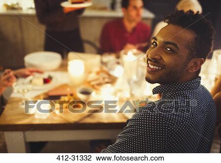 Portrait smiling man enjoying candlelight Christmas dinner View Large Photo Image Stock Image - Portrait smiling man enjoying candlelight Christmas dinner. Fotosearch