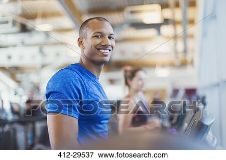 Portrait smiling man on treadmill at gym View Large Photo Image Stock Photo - Portrait smiling man on treadmill at gym. Fotosearch