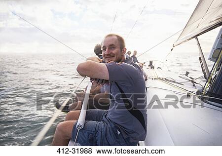Stock Photo - Portrait smiling man sailing on sailboat. Fotosearch