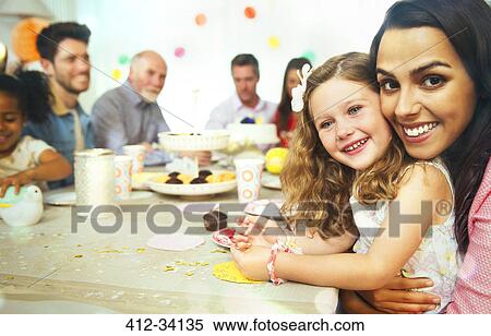 Portrait smiling mother and daughter hugging at birthday party table View Large Photo Image Stock Photography - Portrait smiling mother and daughter hugging at birthday party table. Fotosearch