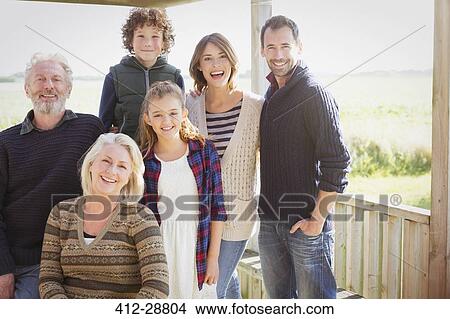 Portrait smiling multi-generation family on sunny porch View Large Photo Image Picture - Portrait smiling multi-generation family on sunny porch. Fotosearch