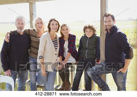 Portrait smiling multi-generation family on sunny porch View Large Photo Image Stock Image - Portrait smiling multi-generation family on sunny porch. Fotosearch