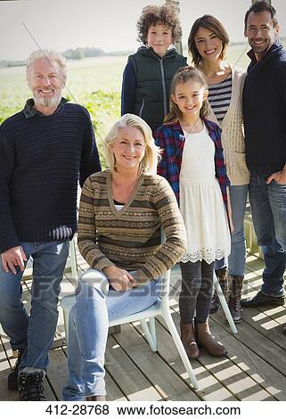 Stock Photo - Portrait smiling multi-generation family on porch. Fotosearch
