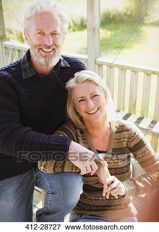 Stock Photo - Portrait smiling senior couple on porch. Fotosearch