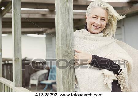Portrait smiling senior woman wearing shawl on windy porch View Large Photo Image Stock Image - Portrait smiling senior woman wearing shawl on windy porch. Fotosearch