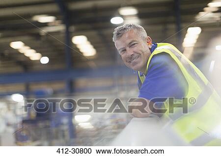 Portrait smiling supervisor in steel factory View Large Photo Image Stock Image - Portrait smiling supervisor in steel factory. Fotosearch