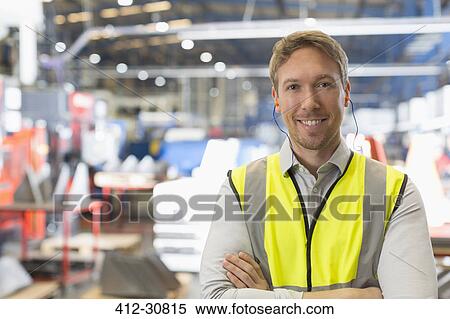 Stock Photography - Portrait smiling supervisor in steel factory. Fotosearch