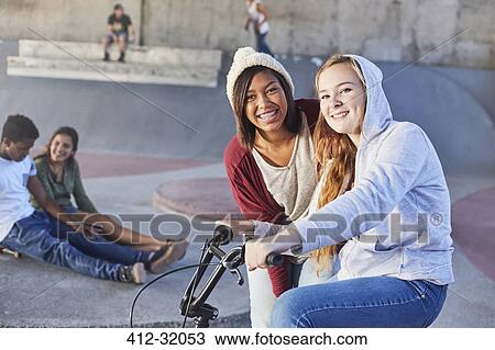 Portrait smiling teenage girls with BMX bicycle at skate park View Large Photo Image Stock Image - Portrait smiling teenage girls with BMX bicycle at skate park. Fotosearch