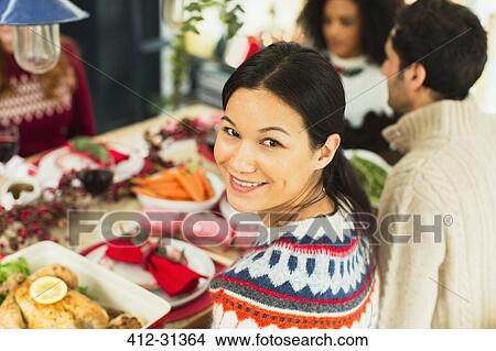Picture - Portrait smiling woman at Christmas dinner. Fotosearch