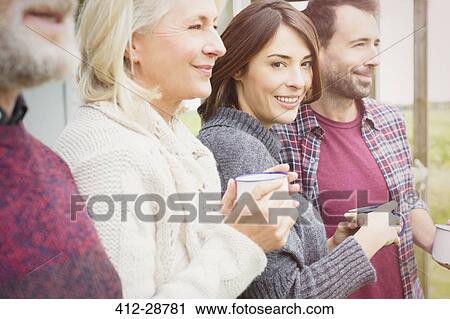 Portrait smiling woman drinking coffee with husband and parents View Large Photo Image Stock Image - Portrait smiling woman drinking coffee with husband and parents. Fotosearch