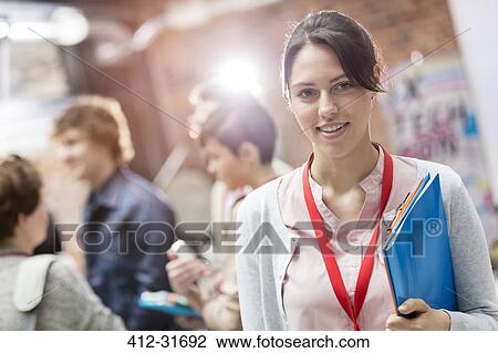 Portrait smiling woman holding folder at technology conference View Large Photo Image Stock Image - Portrait smiling woman holding folder at technology conference. Fotosearch