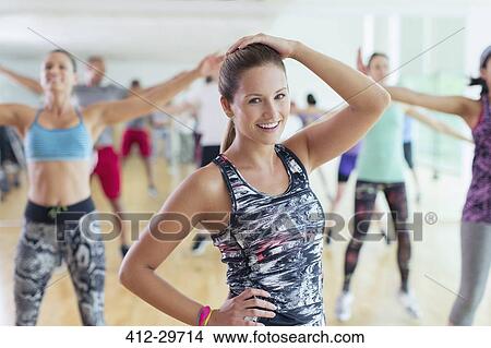 Picture - Portrait smiling woman in exercise class. Fotosearch