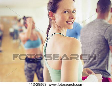 Stock Image - Portrait smiling woman in exercise class. Fotosearch