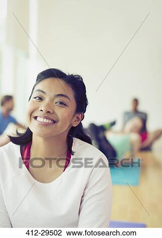 Stock Image - Portrait smiling woman in yoga class. Fotosearch