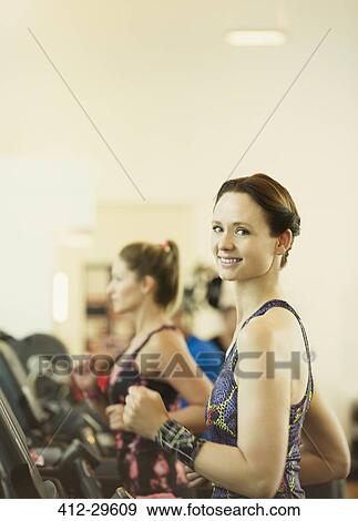 Portrait smiling woman jogging on treadmill at gym View Large Photo Image Stock Photo - Portrait smiling woman jogging on treadmill at gym. Fotosearch