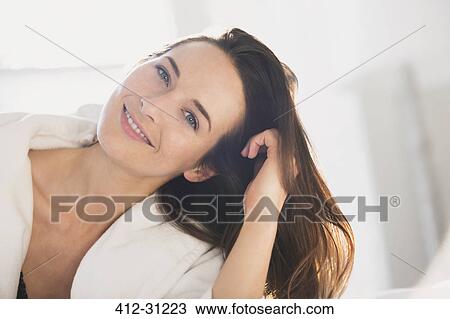 Portrait smiling woman leaning with hand in hair View Large Photo Image Stock Image - Portrait smiling woman leaning with hand in hair. Fotosearch