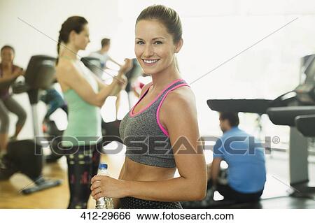 Portrait smiling woman resting at gym View Large Photo Image Stock Photograph - Portrait smiling woman resting at gym. Fotosearch