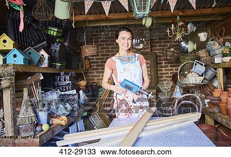 Portrait smiling woman with power sander in workshop View Large Photo Image Stock Image - Portrait smiling woman with power sander in workshop. Fotosearch